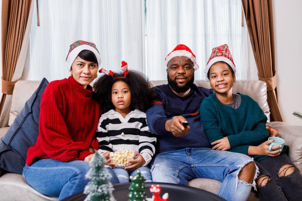 Download Free Stock Photo of Family watching something, sitting together on the couch 
