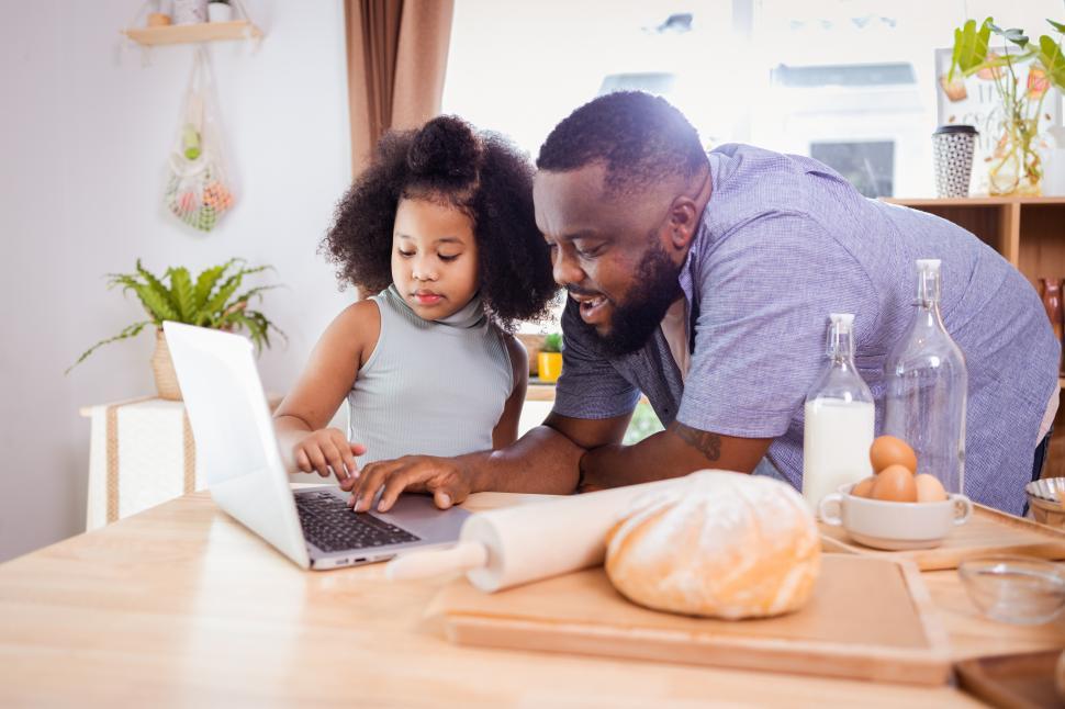 Free Image of Father and Daughter Prepare to Bake using Online Recipe 