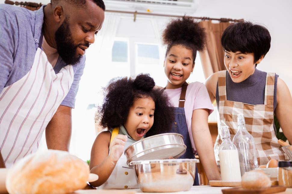 Free Image of Excited girl with family in the kitchen 