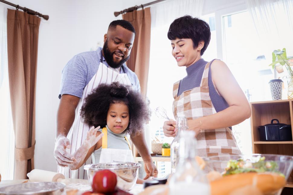 Free Image of Little girl in the kitchen with her parents 
