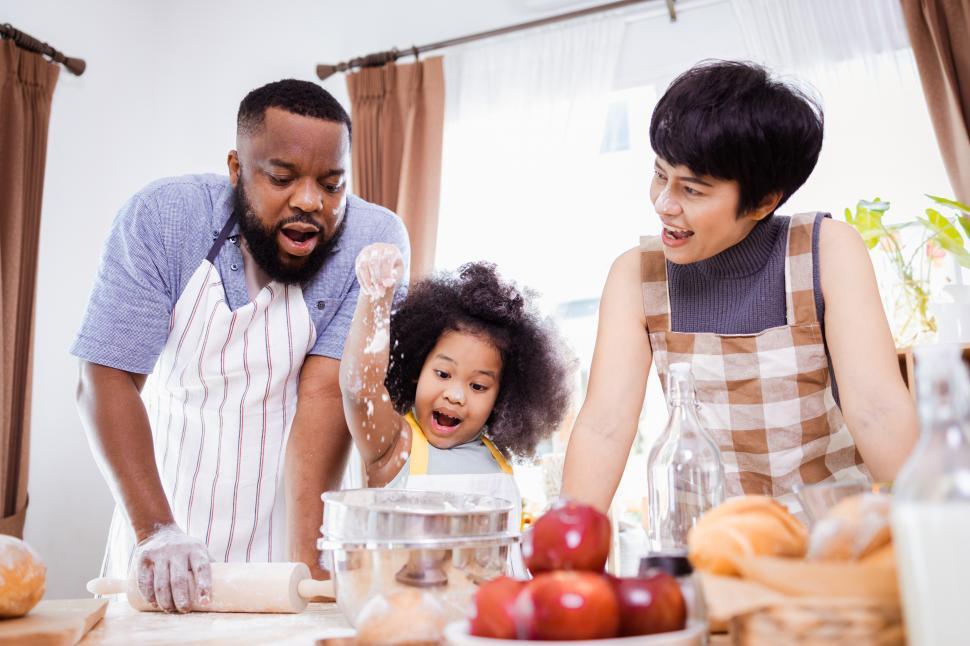 Download Free Stock Photo of Excited kid baking with her parents 