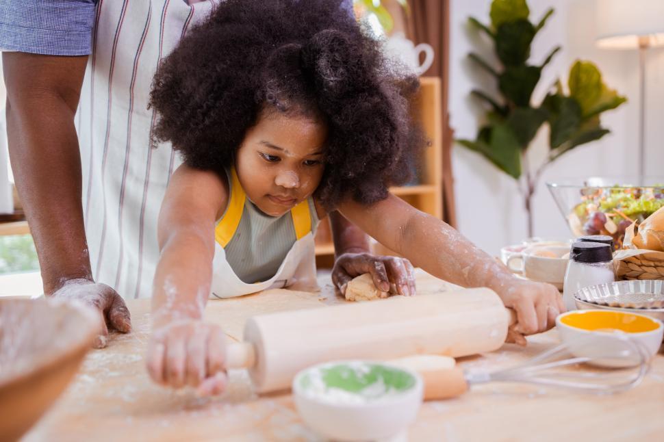 Free Image of Young girl rolling out dough 