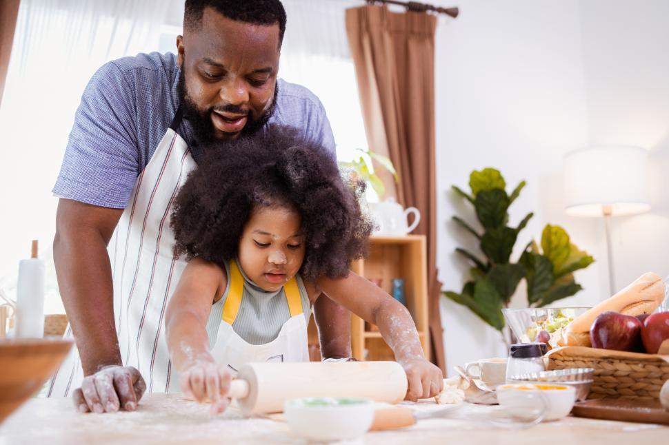 Download Free Stock Photo of Father and daughter rolling dough 