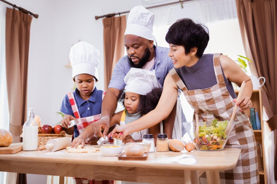 Download Free Stock Photo of Young family cooking together 