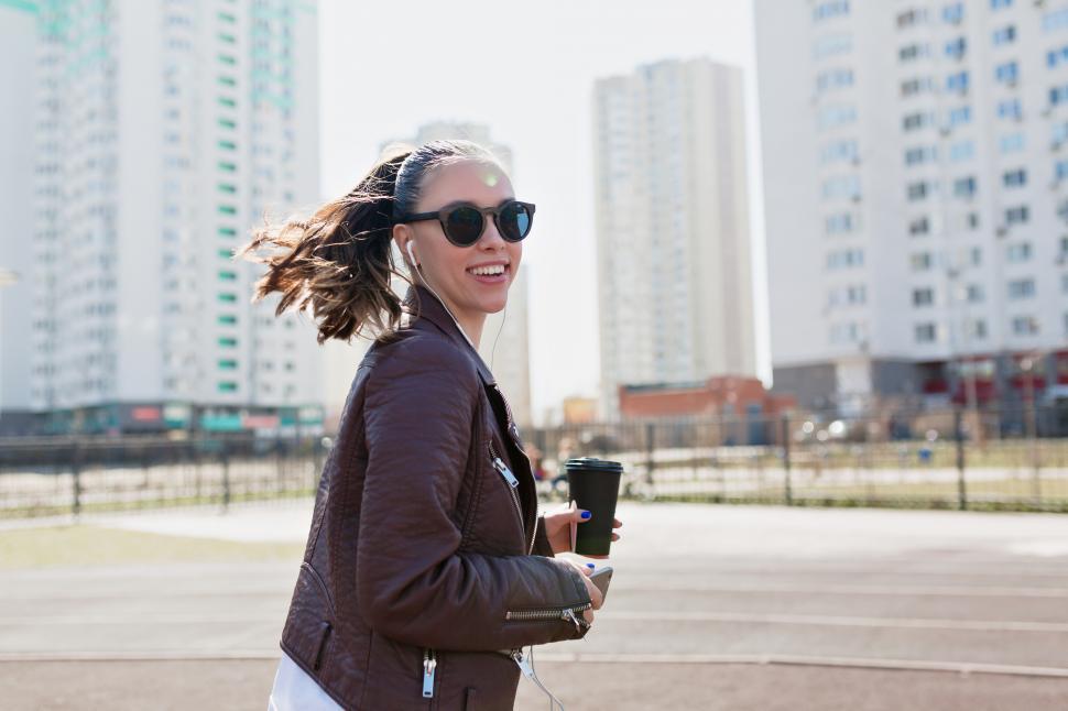 Free Image of Modern happy woman with collected hair in dark sunglasses 