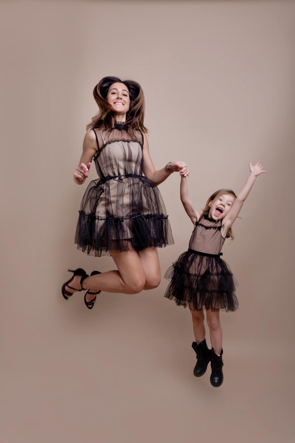 Download Free Stock Photo of Family shot of young mother with daughter jumping in air 