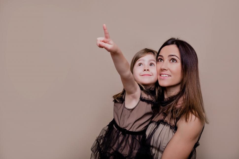 Download Free Stock Photo of Child pointing in the air, with mother 