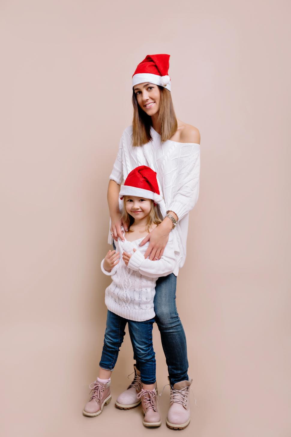 Free Image of Studio portrait of young attractive woman with her little daughter 