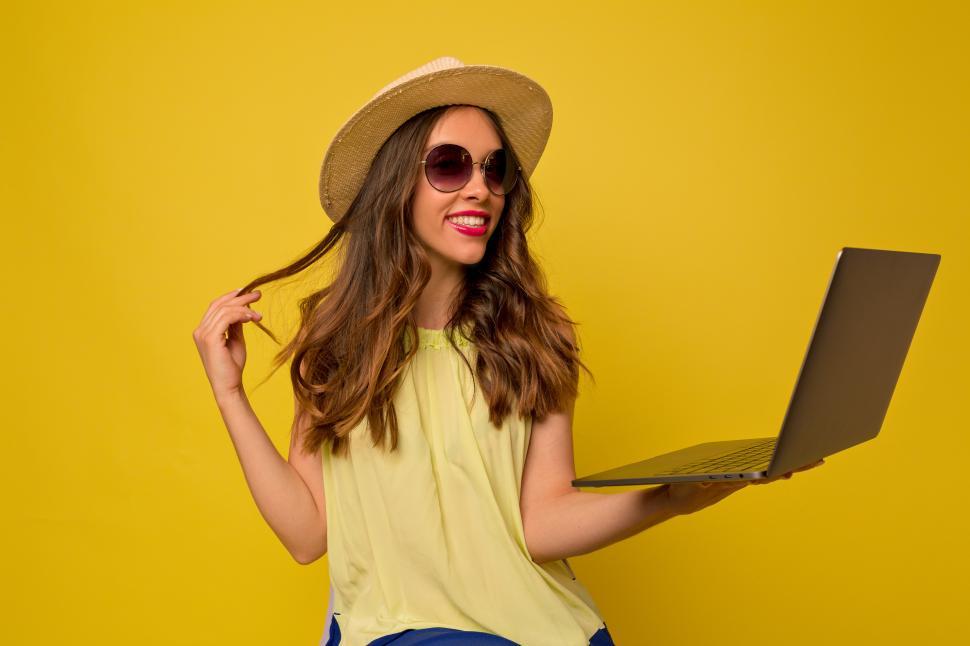 Free Image of Attractive girl with light-brown curly hair working with laptop 