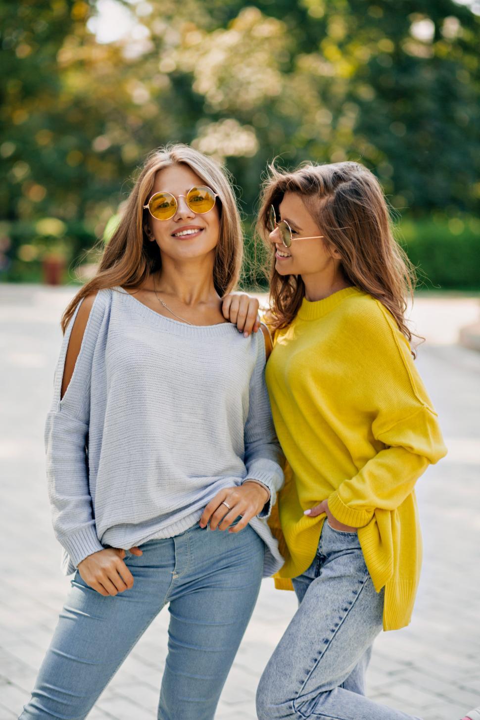 Download Free Stock Photo of Two happy funny hipster girls in bright glasses and pullovers 