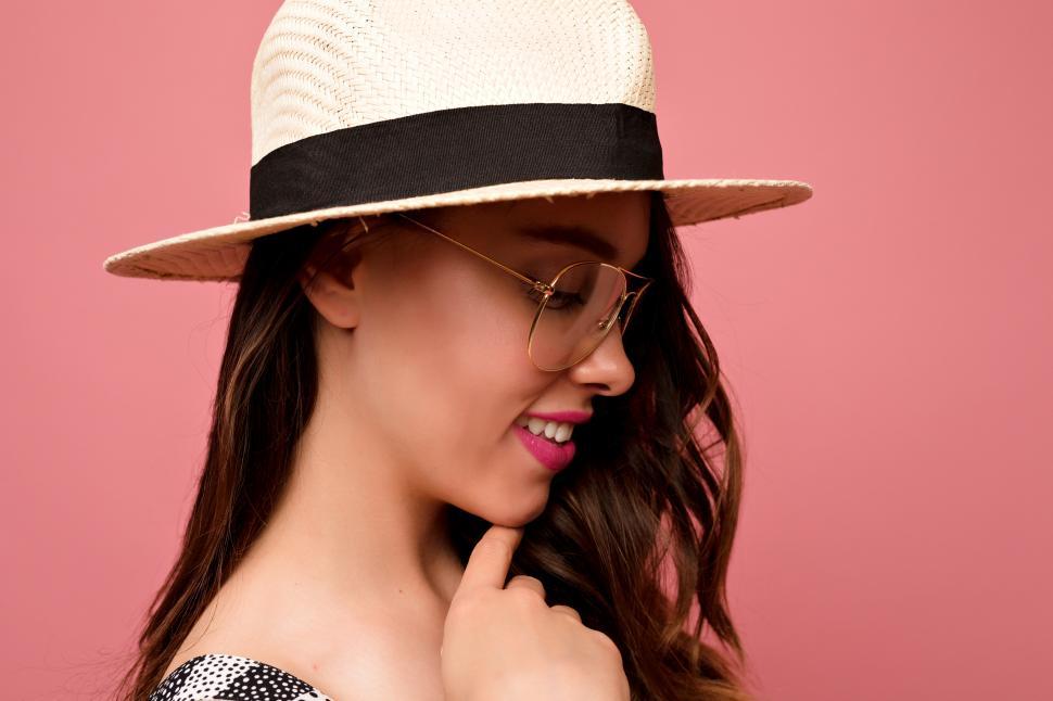 Free Image of Indoor portrait of lovely girl with dark hair wearing hat 