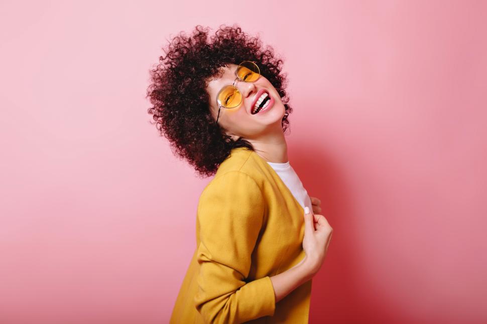 Download Free Stock Photo of Laughing girl with short ringlets dressed yellow jacket 