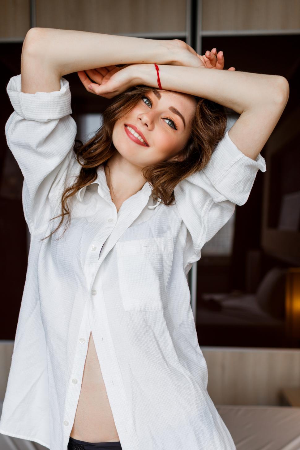 Download Free Stock Photo of Portrait of beautiful brunette  woman in  a large casual white shirt 