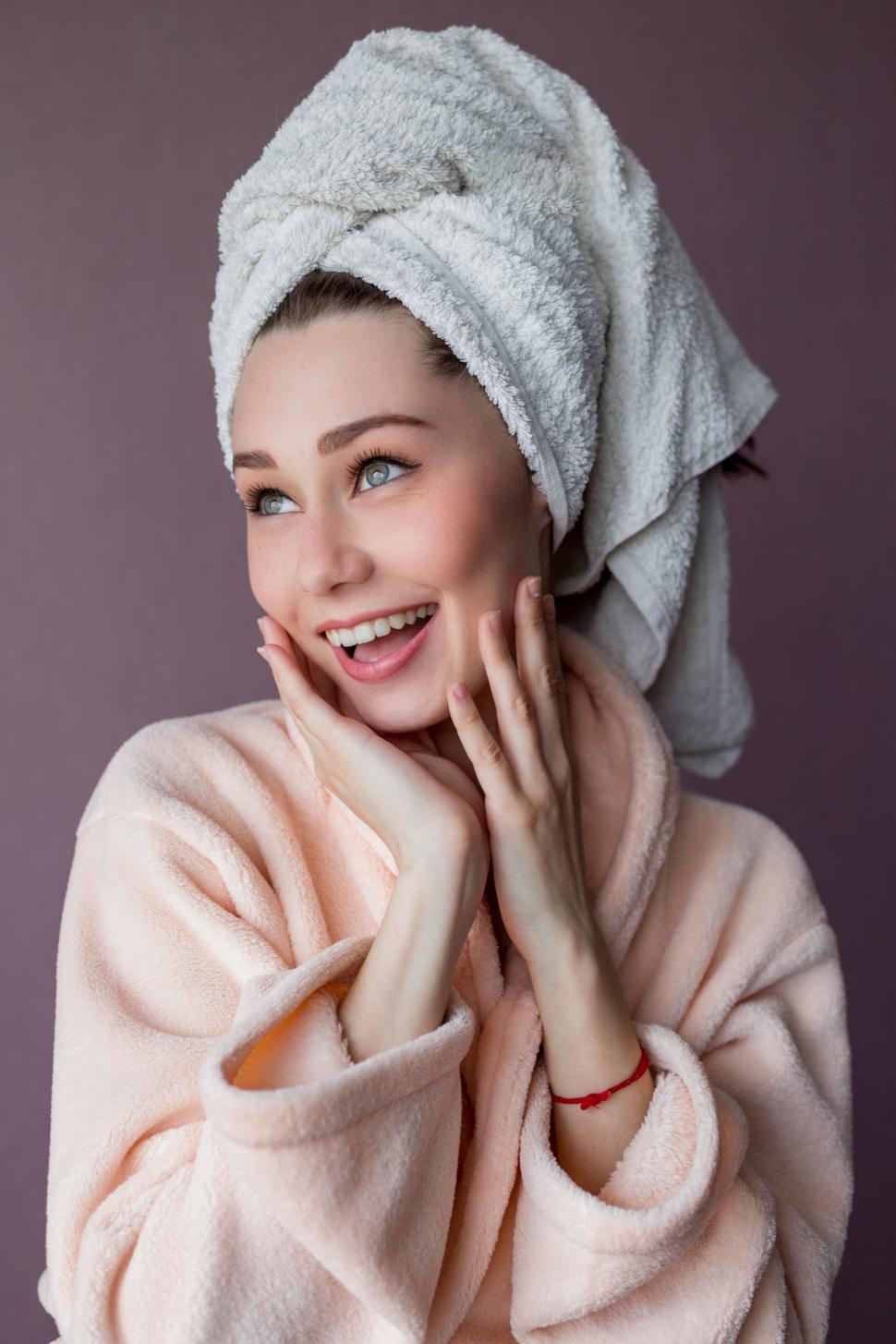 Download Free Stock Photo of Smiling young woman wearing bathrobe and towel 