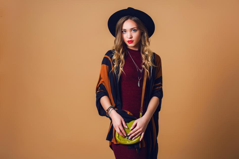 Free Image of Portrait of young fresh blonde  woman in brown straw poncho 