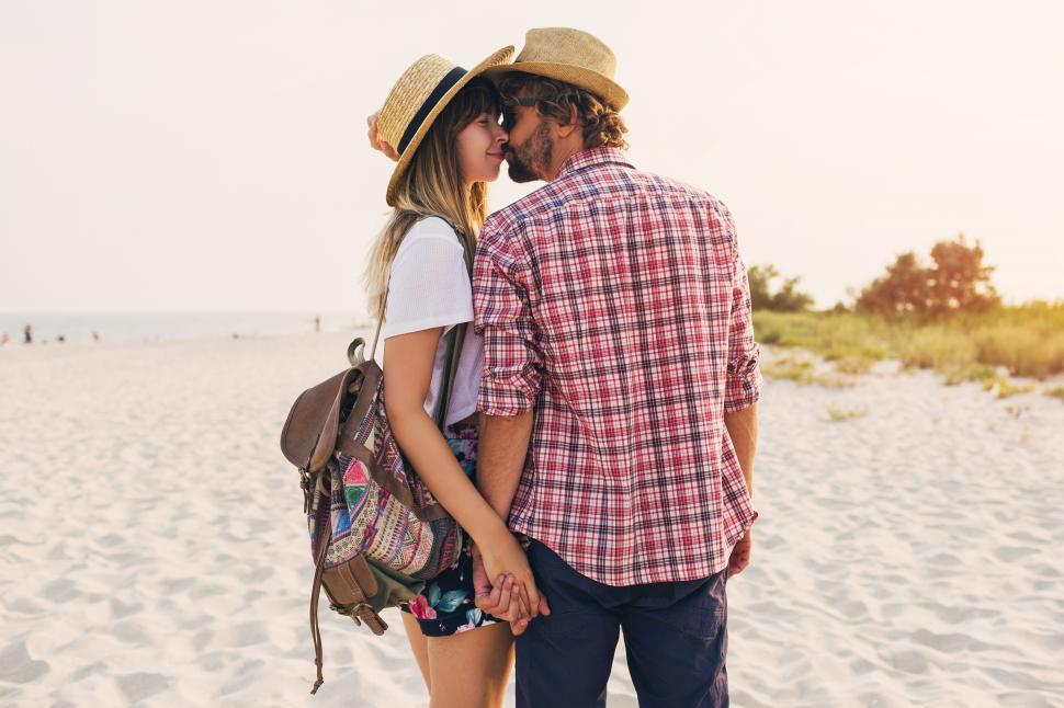 Free Image of Couple in love walking on the beach 