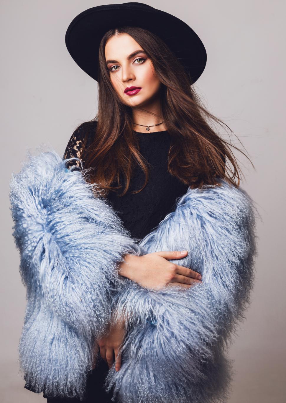 Free Image of Young model in stylish winter fluffy coat and black hat 