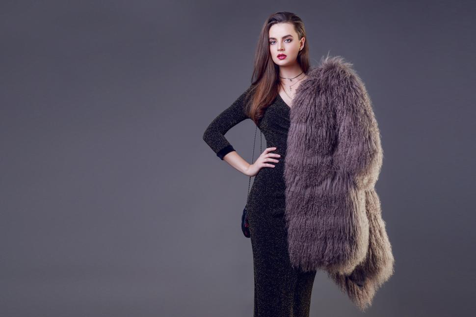 Free Image of Elegant woman with stylish fur coat posing in studio 
