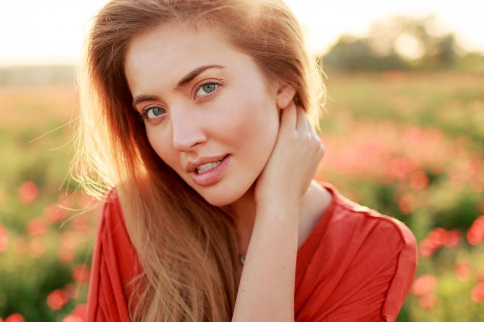 Free Image of Close up beauty portrait of woman with perfect skin posing in the sunny field. 