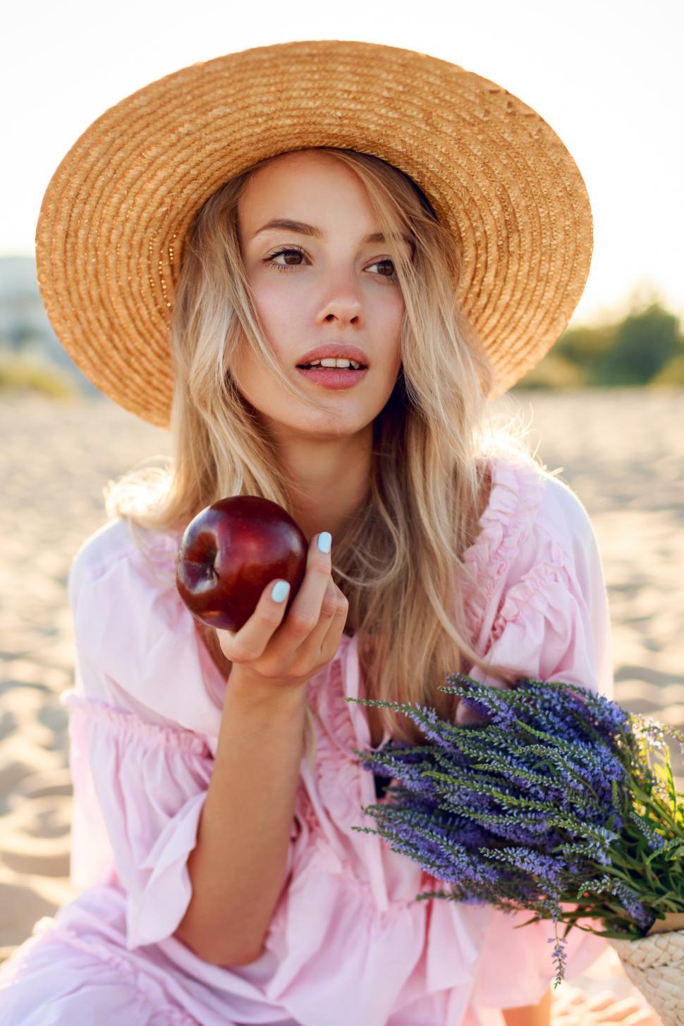 Free Image of Close up portrait of blonde girl in straw hat enjoying vacation 
