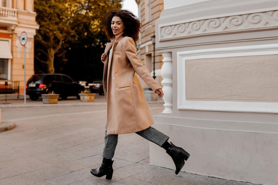 Free Image of Woman in stylish luxury beige coat and velvet sweater 