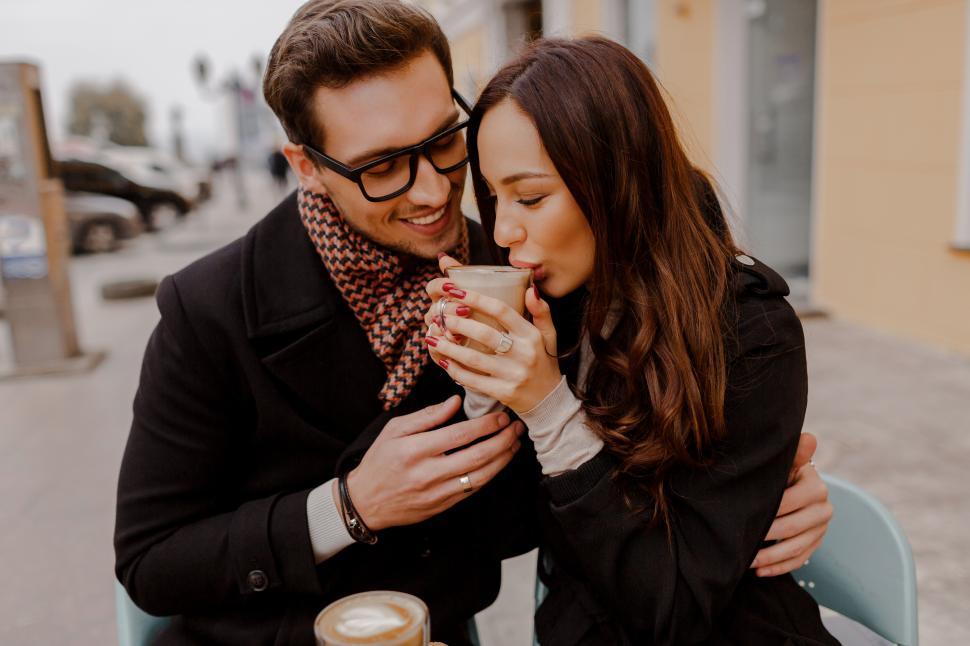 Free Image of Romantic couple dating in cozy cafe on the street 