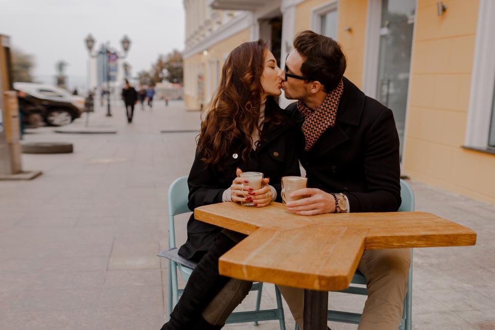 Free Image of Fashionable couple in love sitting in street cafe 