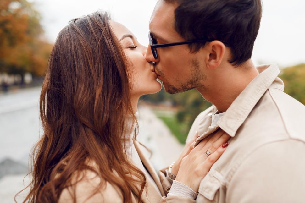 Free Image of Handsome man with his wife kissing outside. Romantic moments. 