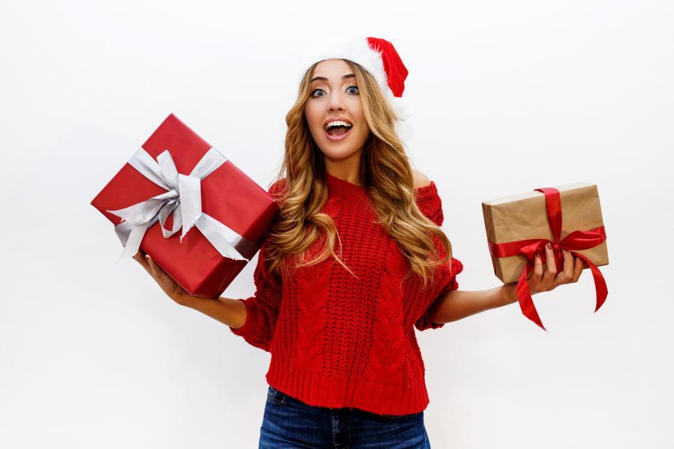 Free Image of Woman celebrating new year party holding gifts 