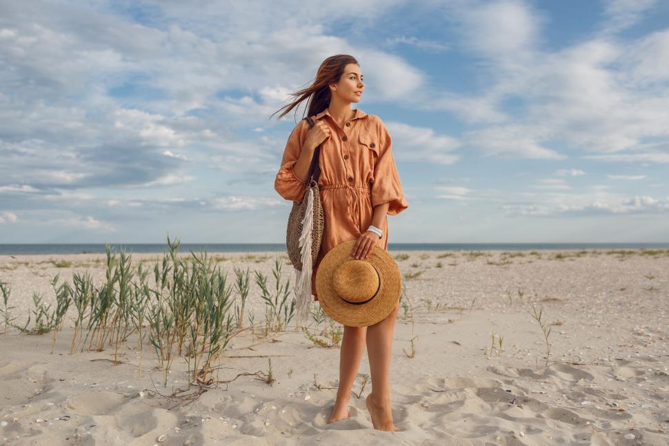 Free Image of Female in trendy linen dress on the beach 