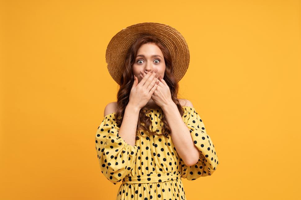 Free Image of Woman with surprised face covers her  mouth with her hands 