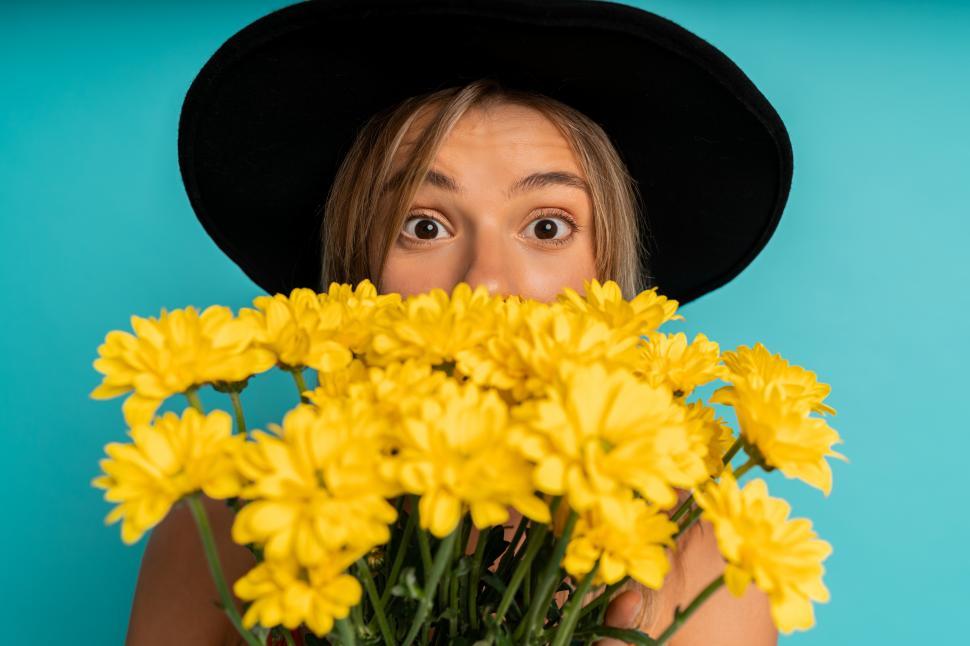 Free Image of Woman posing with yellow flowers 