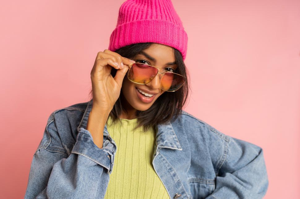 Free Image of Black woman in pink hat and fancy sunglasses 