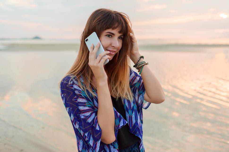 Free Image of Pensive woman holding mobile phone 