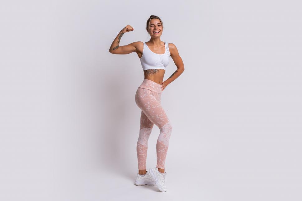 Free Image of Athletic woman showing muscles of arms and legs 
