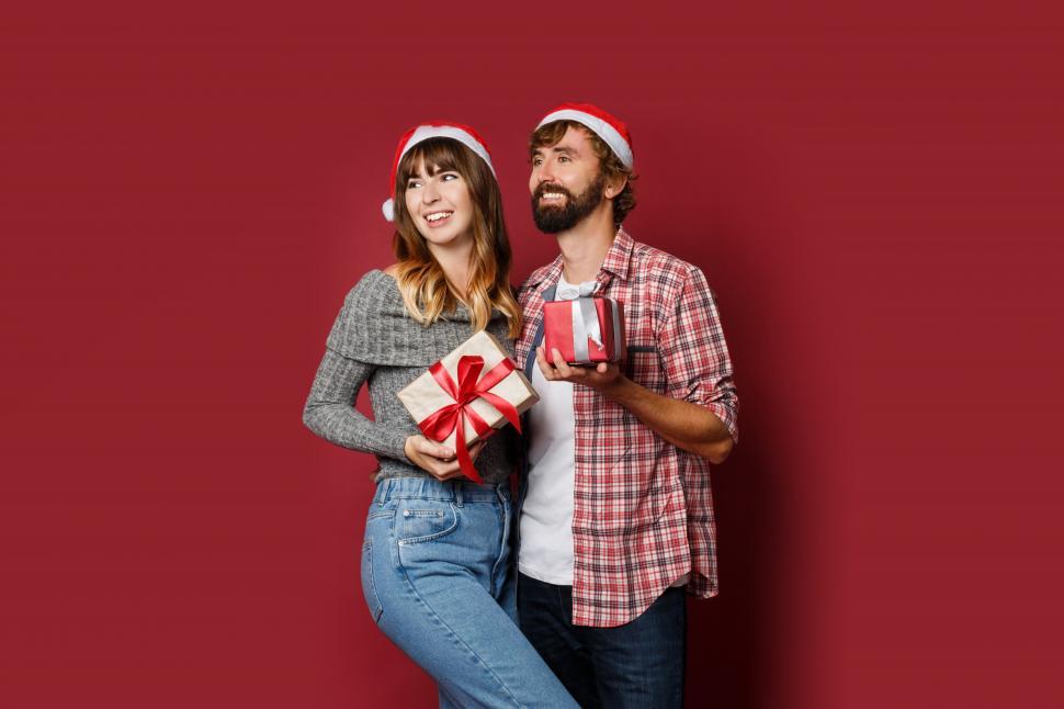 Free Image of Couple in love holding Christmas gift boxes 