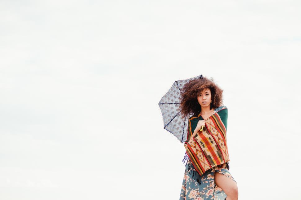 Free Image of black girl on the shore with an umbrella 