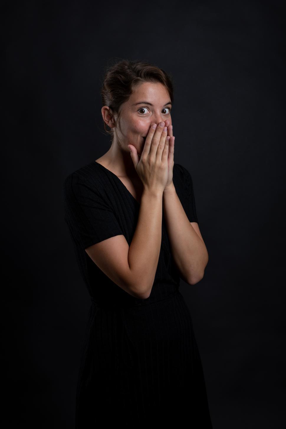 Free Image of A young woman surprised by something in a studio shot 