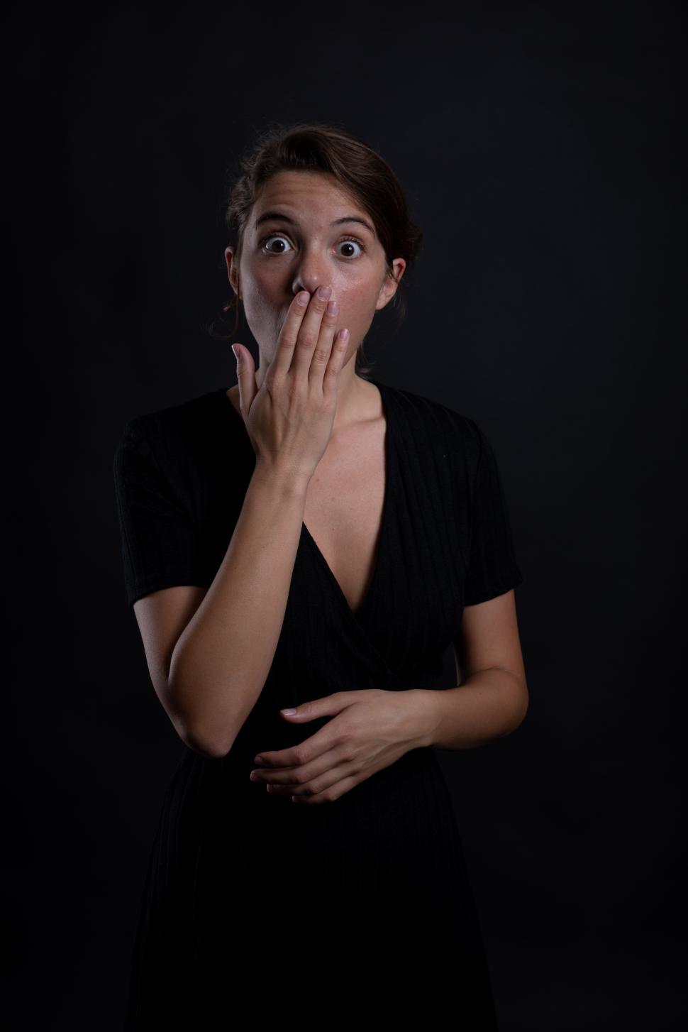 Free Image of A young woman shocked by something in a studio shot 