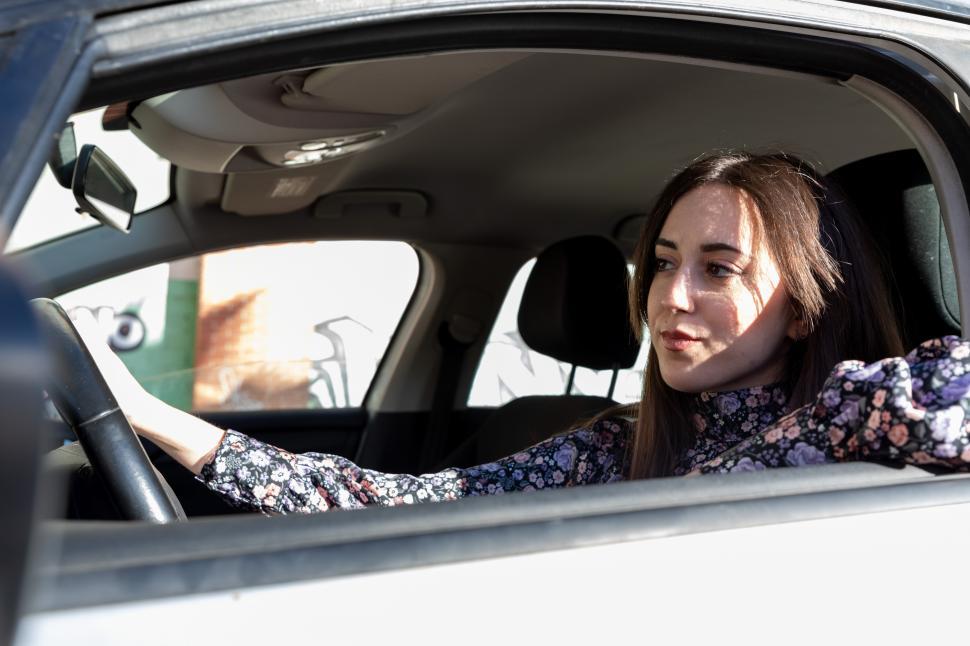 Free Image of A young woman driving a car 
