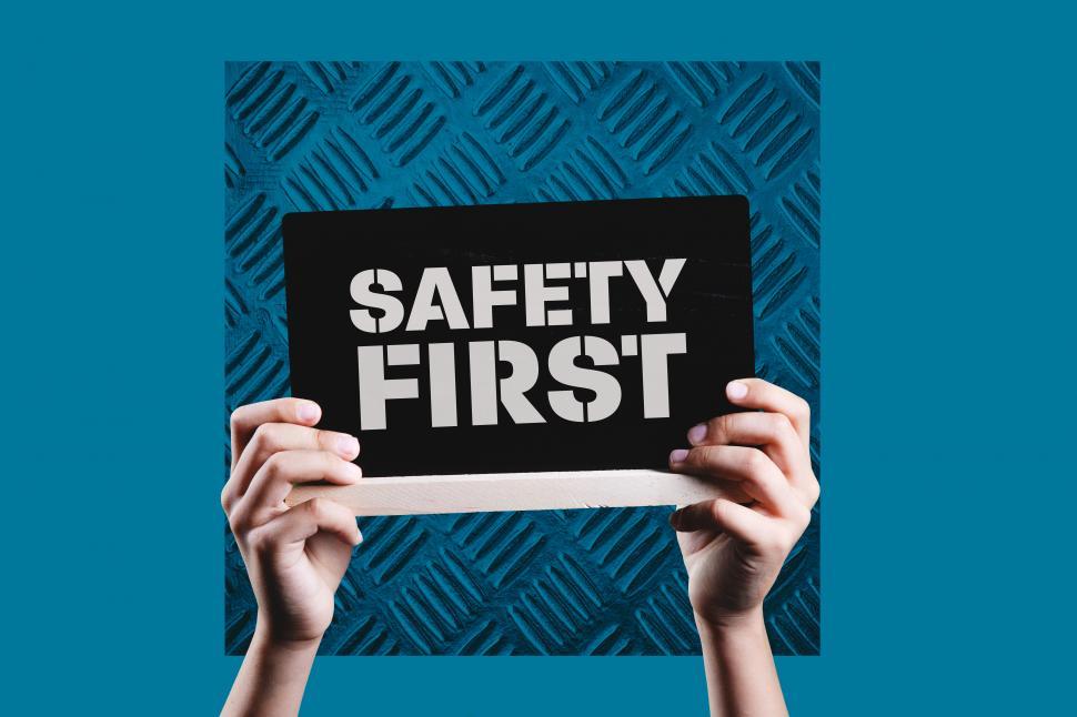Free Image of hands holding placard with the message SAFETY FIRST on 