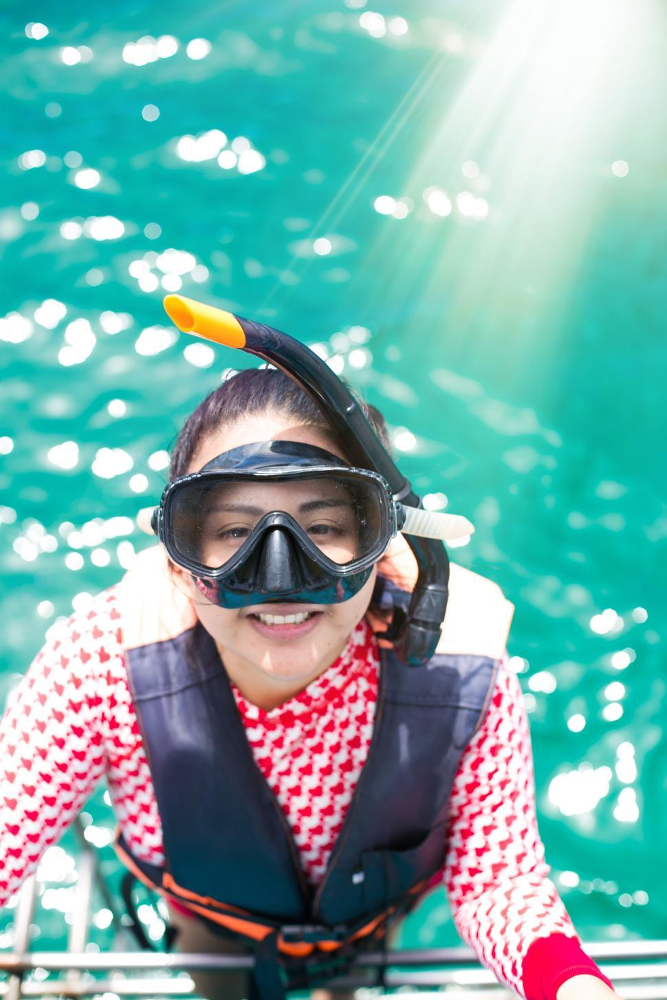 Free Image of Happy snorkel girl having fun in ocean water snorkeling on Carib 