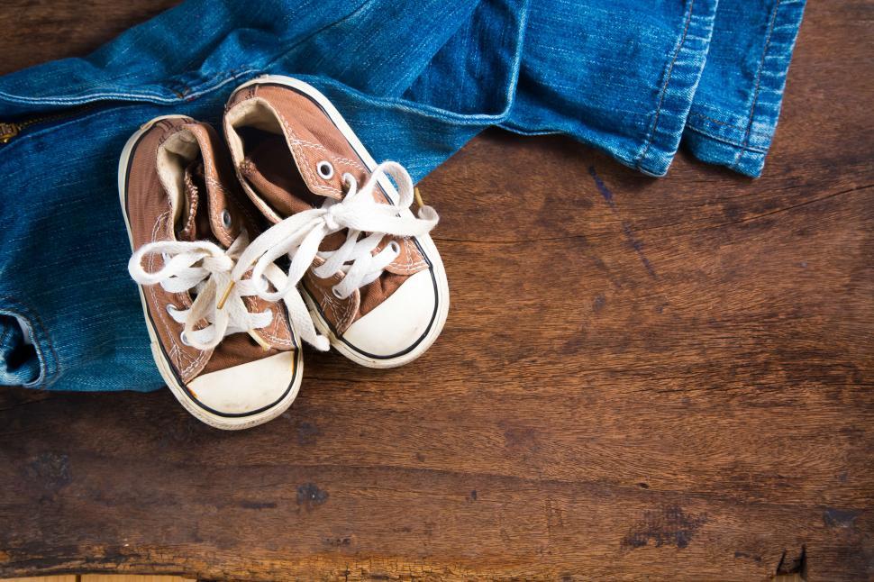 Free Image of Accessories,  jeans and sneakers on wooden background 