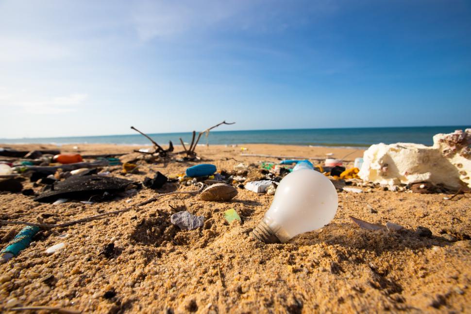 Free Image of Light blub, glass bottles and garbage waste on the beach 