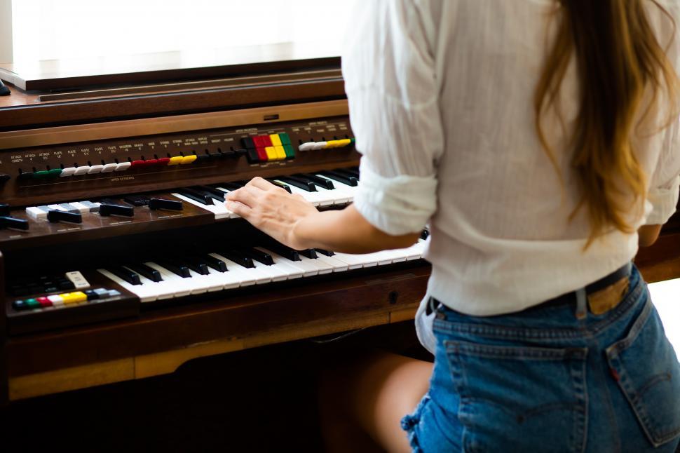 Free Image of Woman playing organ  