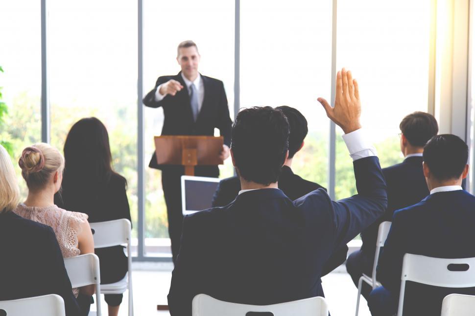 Free Image of Rear view of business man raising hand during seminar 