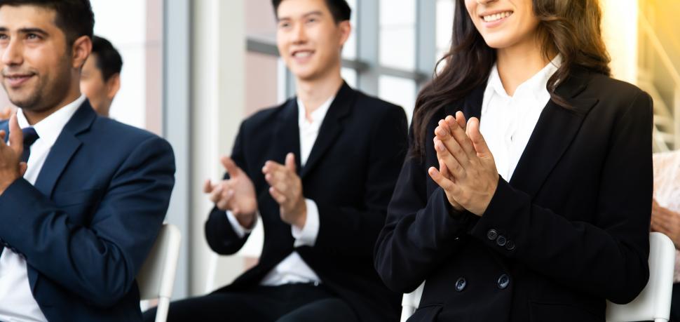 Free Image of Smiling audience applauding at a business seminar 