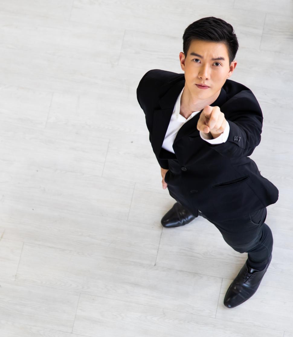 Free Image of Young Asian businessman executive looking up 