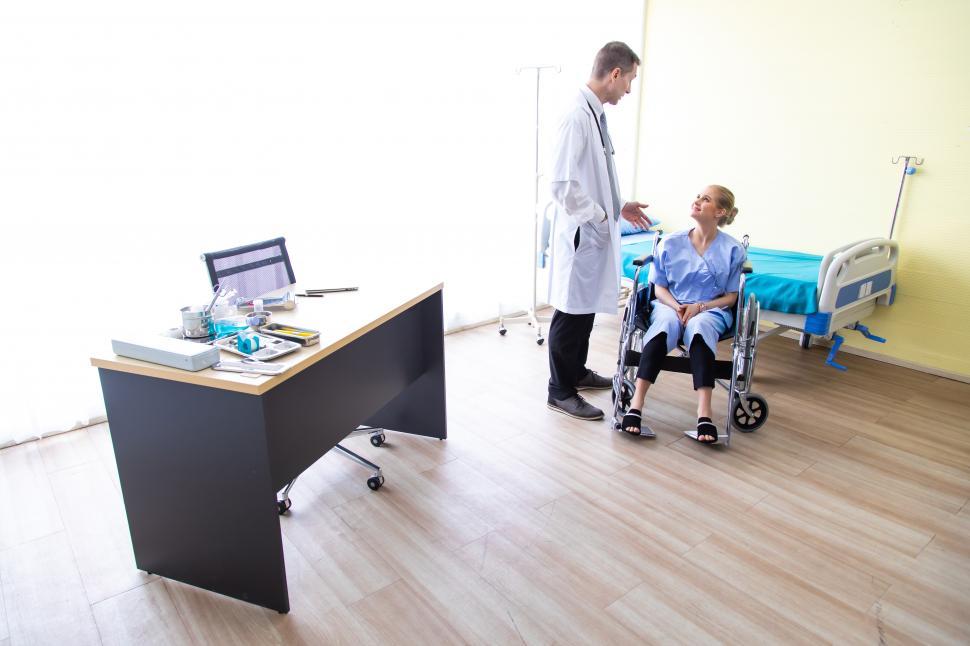 Free Image of Doctor speaking with woman in wheelchair 