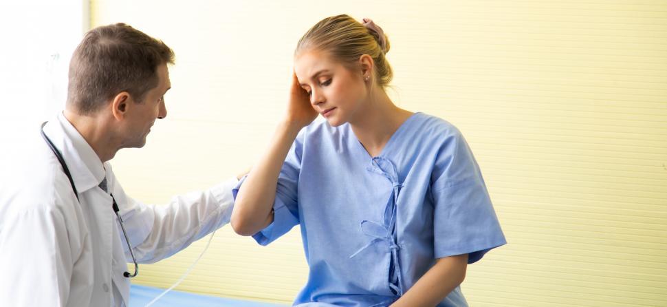 Free Image of Doctor reassuring a female patient in  hospital room 
